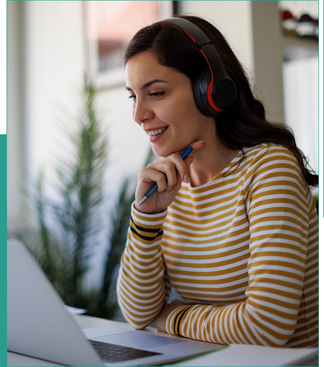 Woman with headphones working on laptop.