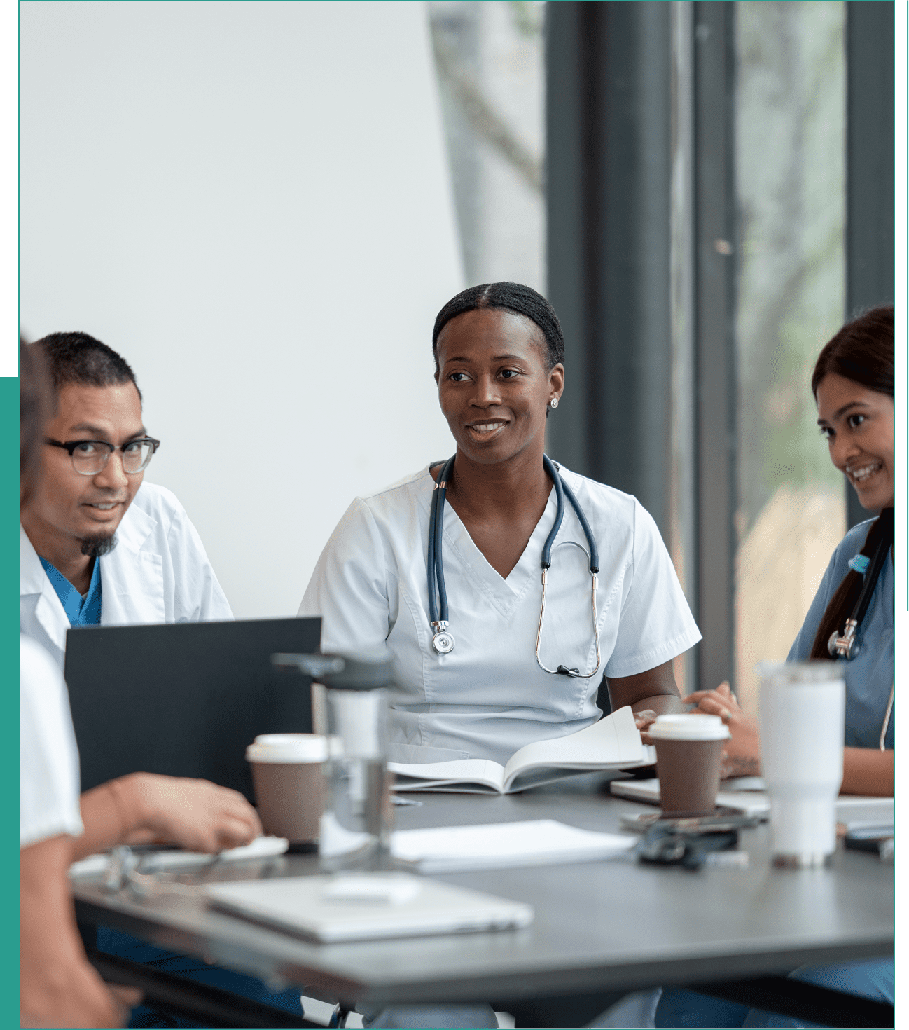 Medical team meeting around a table.