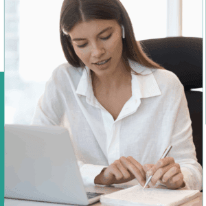 Woman working at desk with laptop.