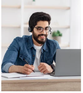 Man with headphones working on laptop.