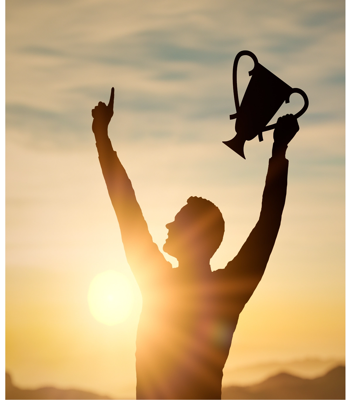 Silhouette holding trophy against sunset sky.