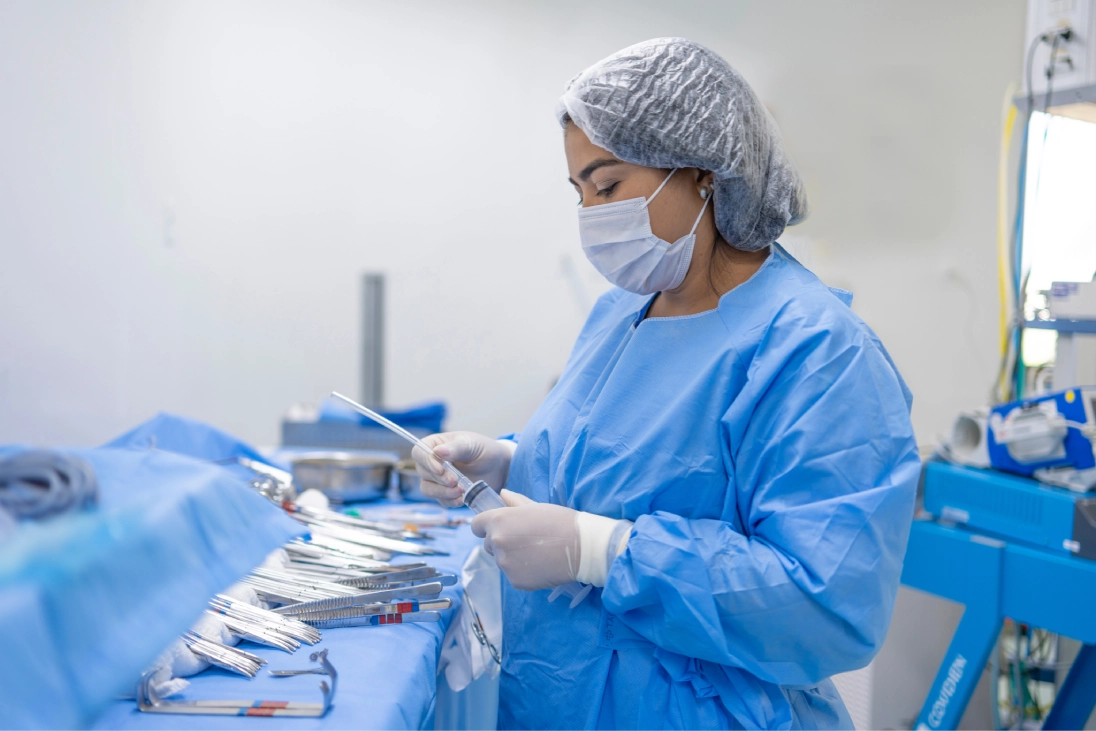 Medical professional organizing surgical instruments in scrubs.